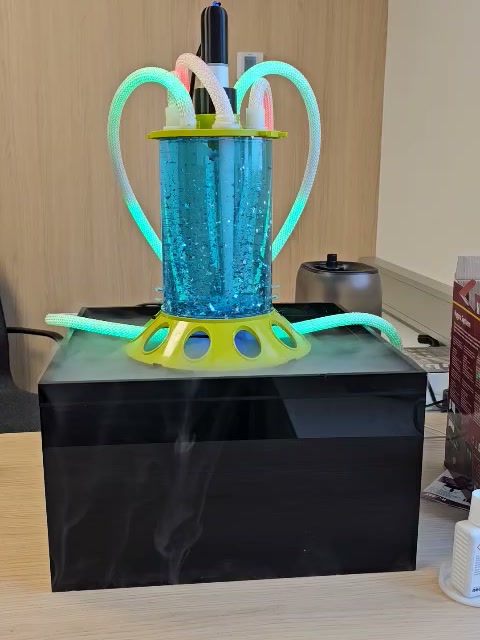 Bioreactor exhibition system running: glitter fluid, LED light ropes and fog around the base